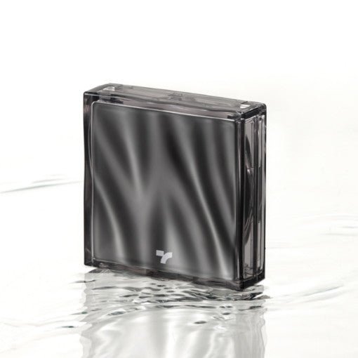 Compact black cushion foundation case with subtle wave reflections standing on rippled water surface