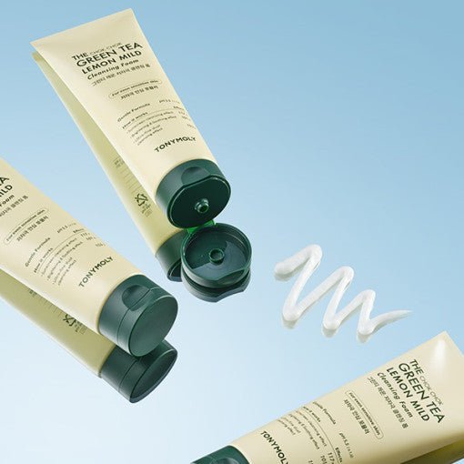 Three pale yellow tubes of mild cleansing foam with black caps, one open showing creamy foam swirled on blue surface