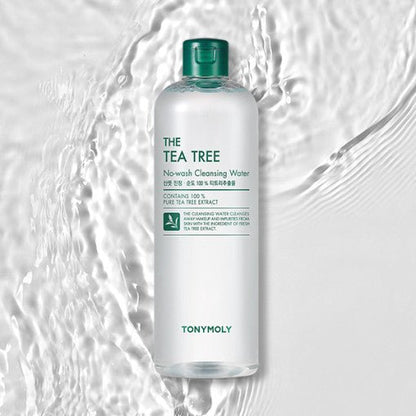 Clear bottle of tea tree no-wash cleansing water with green cap placed on textured water surface background