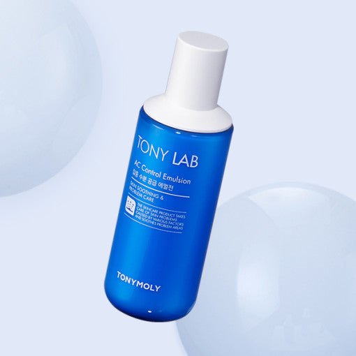 Blue bottle of fast-absorbing AC Control Emulsion with white cap floating against a pale blue background