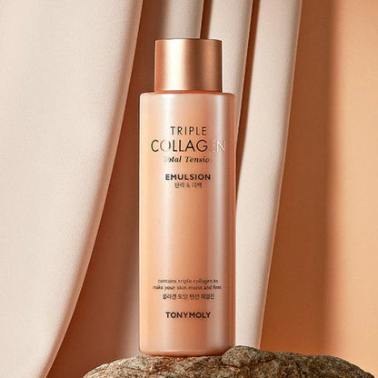 Tall peach-toned emulsion bottle with gold cap, placed on stone against soft beige fabric background