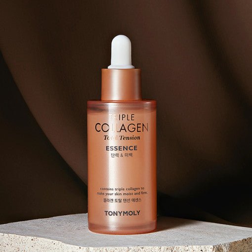 Frosted amber dropper bottle of collagen essence standing on textured stone with warm brown background