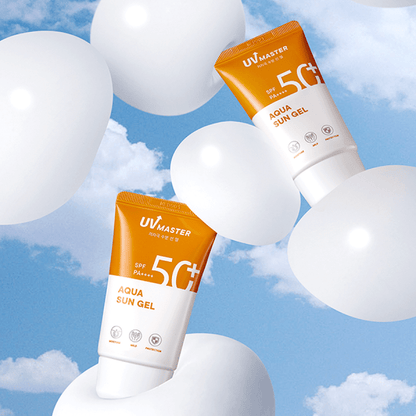 Two orange and white sun gel tubes floating among white balloons against a bright blue sky with clouds