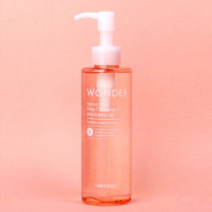 Clear pump bottle of apricot deep cleansing oil on peach background for gentle makeup removal