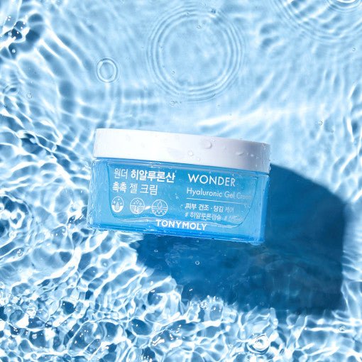Blue jar of hydrating gel cream floating in clear rippling water with sunlight reflections on surface