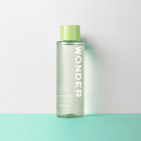 Clear toner bottle with green cap featuring gentle exfoliation benefits on a light green and white background