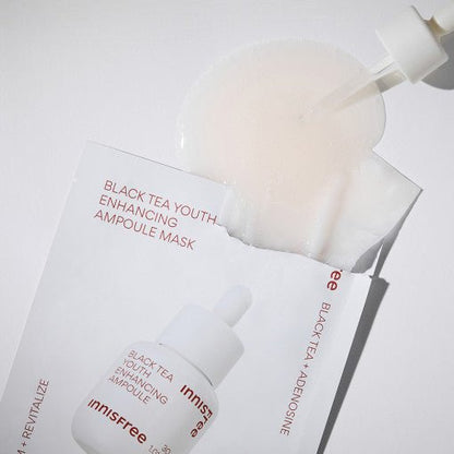 Clear ampoule mask soaked with serum being dispensed from dropper over white packaging featuring skin elasticity boost text