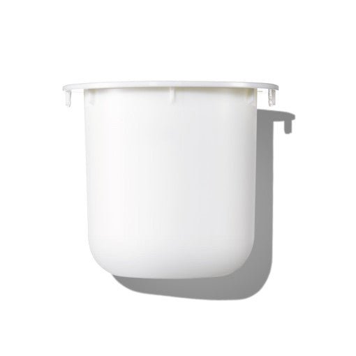 Minimalist white refill container for skincare cream with smooth matte finish casting soft shadow
