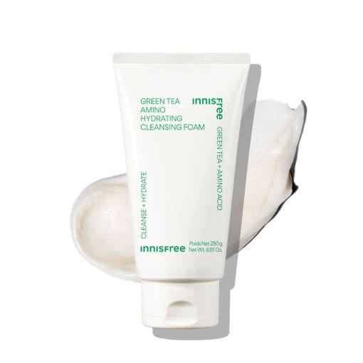 White tube of hydrating cleansing foam with green text positioned on creamy foam swatch in soft light background