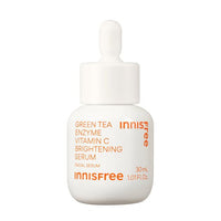 White dropper bottle featuring bright orange text highlighting green tea enzyme and vitamin C brightening serum benefits