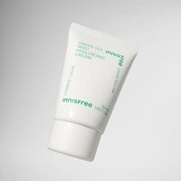 White tube of hydrating green tea seed hyaluronic cream with minimalist green text on a light gray background