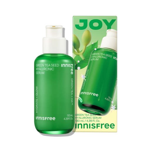 Green bottle of hydrating serum with white pump beside matching green and yellow box featuring natural green tea seed imagery