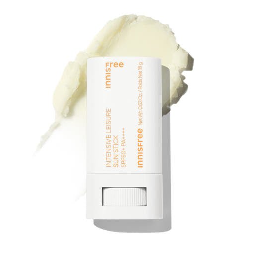 White sun stick container with orange text for high protection sun care and creamy product texture behind it