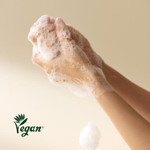 Hands covered in rich lather of gentle body and hand wash with hydration boost, vegan formula indicated by logo