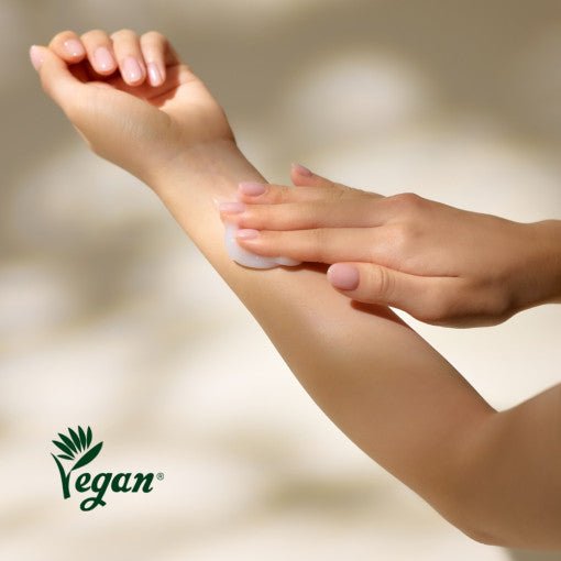 Person applying smooth white lotion on forearm highlighting hydration boost and vegan skincare benefits