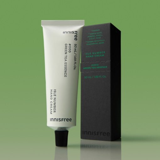 Minimalist tube of hand cream with green tea essence and dark rectangular packaging on green background