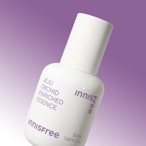 White bottle of enriched essence with purple text against a soft purple gradient background, promoting anti-aging care
