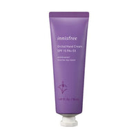 Purple tube of moisturizing hand cream with SPF15 and orchid extract text on plain white background
