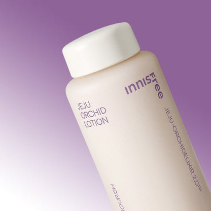 Matte cream bottle of lotion with purple text against a soft gradient lavender background