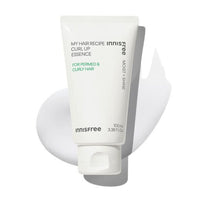 White tube of lightweight curl-up essence for permed and curly hair with smooth cream texture background