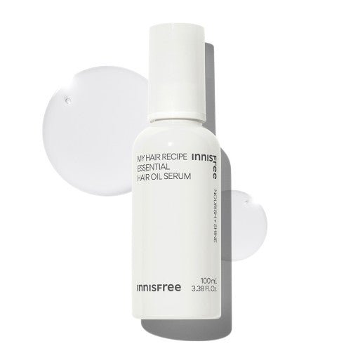 White bottle of hair oil serum with clear oil drops on a white background highlighting deep nourishment benefits