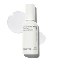 White bottle of nourishing hair oil serum with smooth clear liquid drops on a white background