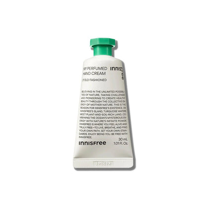 White tube of moisturizing perfumed hand cream with green cap and black text on a white background