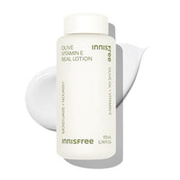 White bottle of moisturizing lotion with olive oil and vitamin E beside smooth lotion swatch on white backdrop