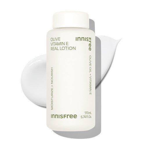 White bottle of moisturizing lotion with olive oil and vitamin E beside smooth lotion swatch on white backdrop
