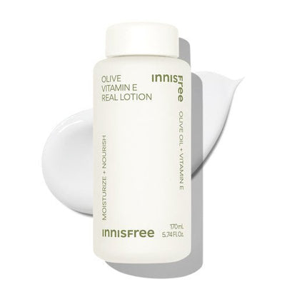 White bottle of moisturizing lotion with olive oil and vitamin E beside smooth lotion swatch on white backdrop