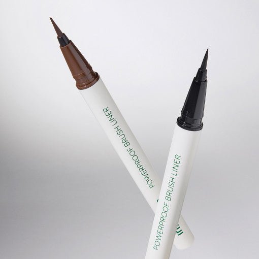 Two powerproof brush liners with fine pointed tips in brown and black shades on a plain white background
