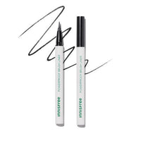 White brush liner pen with fine tip and bold black strokes showcasing precise application on white background