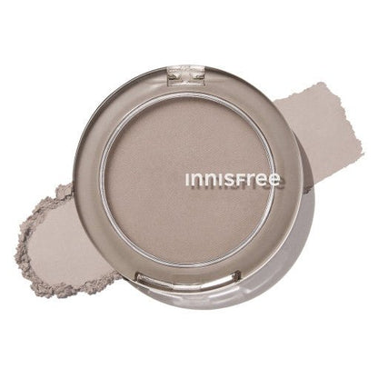 Compact with soft taupe sculpting powder and smooth shading texture on a white background