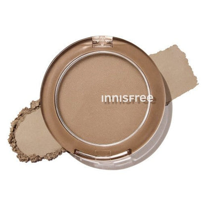 Compact powder shading with natural matte beige tone on transparent brown case against white background