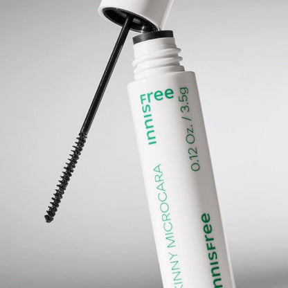 Slim mascara tube with precise black micro brush designed for long-lasting wear on light background
