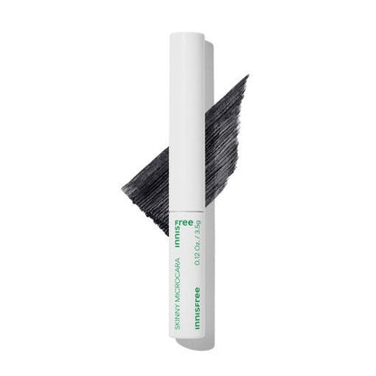 Slim white mascara tube with deep black brush stroke showing long-lasting wear effect on white background