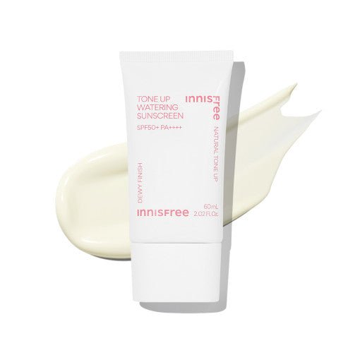 White sunscreen tube with pink text and light beige cream smear on a bright white background