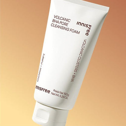 White tube of volcanic BHA pore cleansing foam with minimalist text on warm beige background