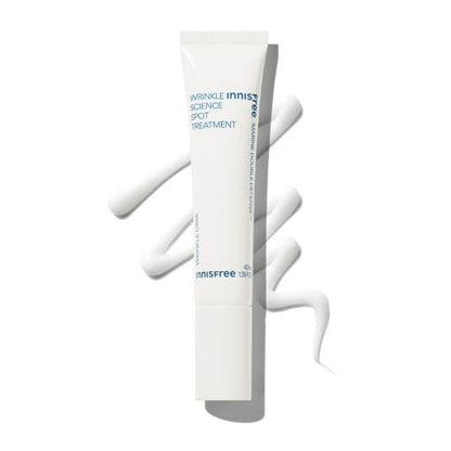 White tube of wrinkle-reducing spot treatment cream with smooth lotion swirls on a bright background