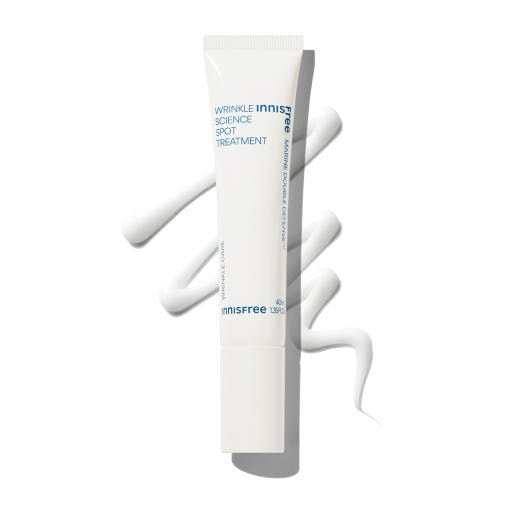 White tube of wrinkle treatment cream with smooth swirls of product on white background for targeted skin care