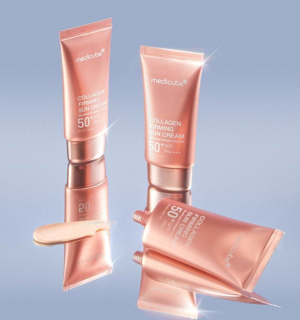 medicube Collagen Firming Sun Cream 50ml tubes in metallic rose gold with high protection SPF50 displayed on reflective surface