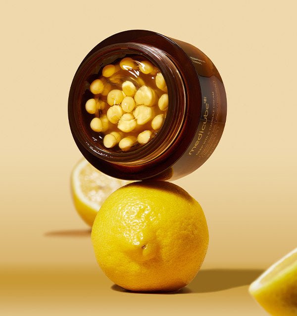 medicube Deep Vita C Capsule Cream 55g open jar showing vitamin C capsules for hydration boost with lemons background