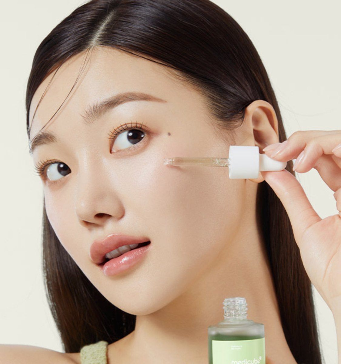 medicube Exosome Cica Ampoule 30ml dropper applying clear serum to cheek for rapid relief skincare benefits