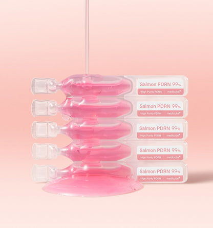 medicube PDRN Pink One Day Serum 1box(1.5ml*10ea) ampoules stacked with pink serum and drip on soft pink background
