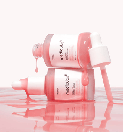 medicube PDRN Pink Peptide Serum 30ml bottles with pink serum dripping to emphasize enhanced elasticity care