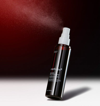 medicube Red Acne Body Peeling Shot 110g in dark bottle with white spray releasing fine mist for effective peeling
