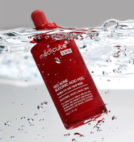 medicube Red Acne Succinic Acid Peel 40g bottle submerged in water with bubbles, acne-clearing skincare product