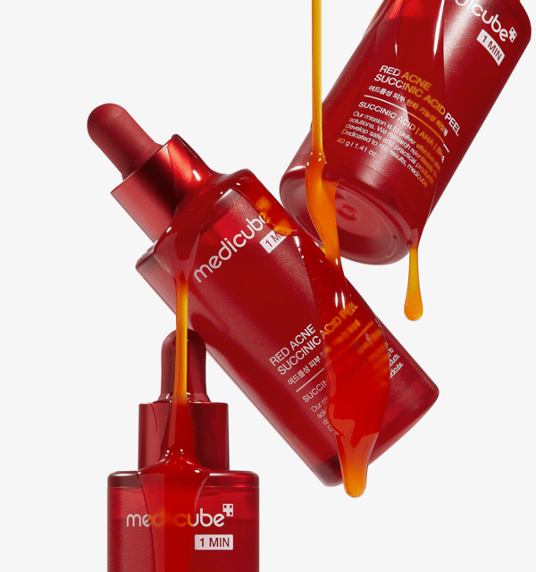 medicube Red Acne Succinic Acid Peel 40g in red bottles with amber-colored peel dripping highlighting acne-clearing effect
