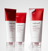 medicube Red Clear Capsule Body Lotion 230ml tubes with smooth texture lotion spilling on one tube against white background