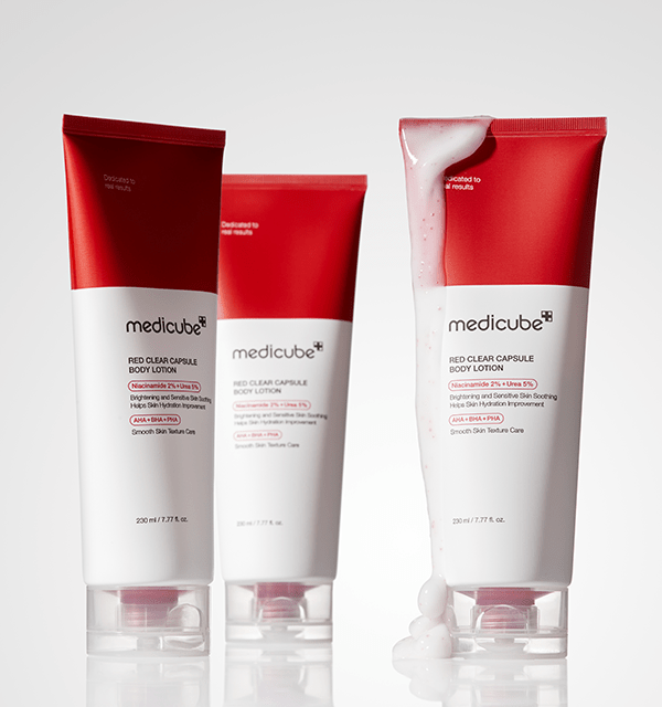 medicube Red Clear Capsule Body Lotion 230ml tubes with smooth texture lotion spilling on one tube against white background